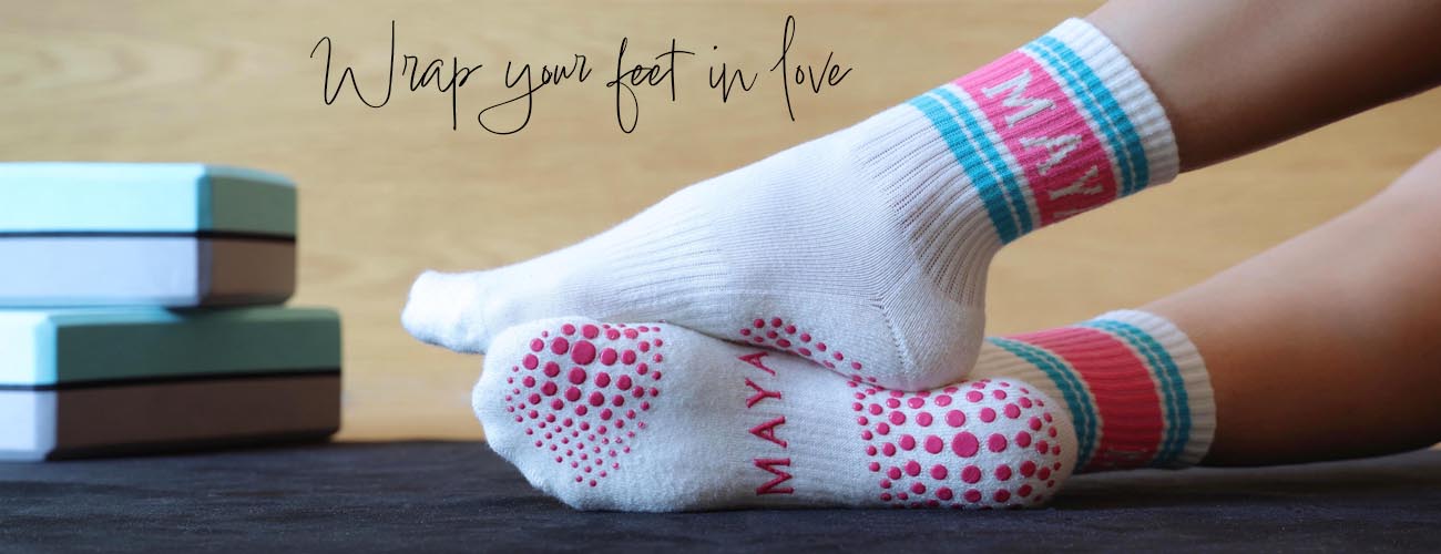 Maya Socks homepage image of signature retro double pilates grip socks on a yoga mat