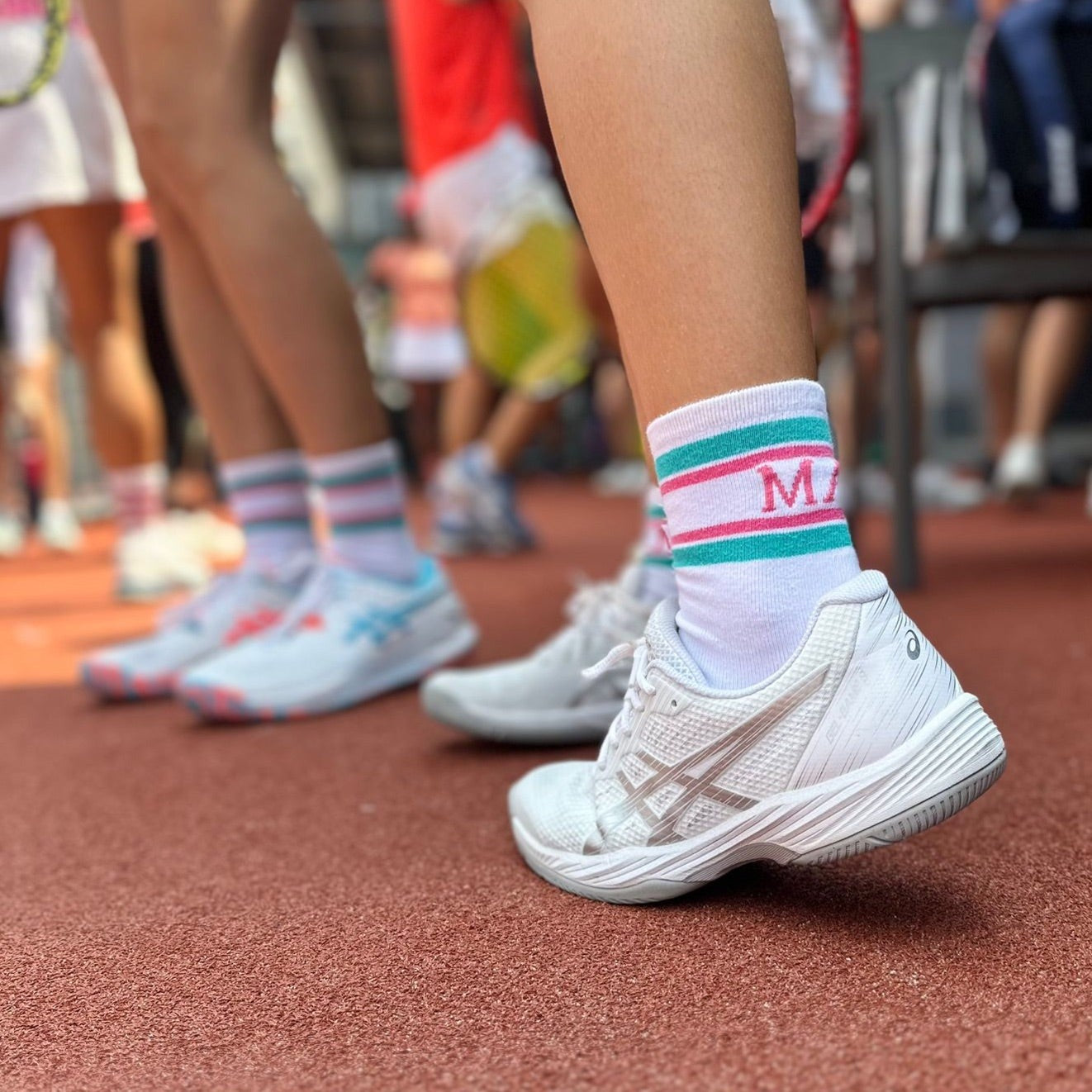 Maya One sock worn in white asics tennis shoes at tennis court 